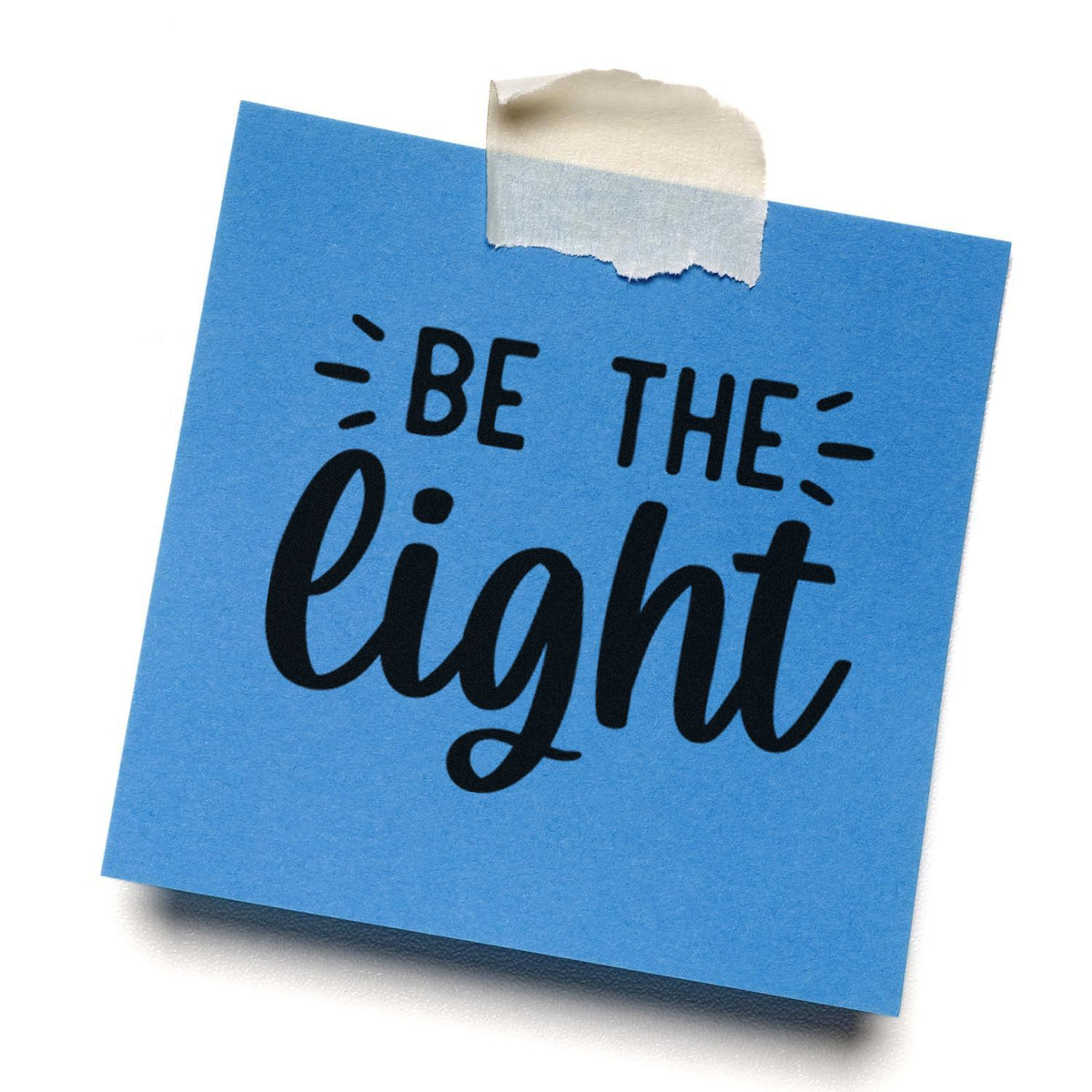 Blue sticky-note style stamp seal with black Be the light lettering and beige tape at the top.