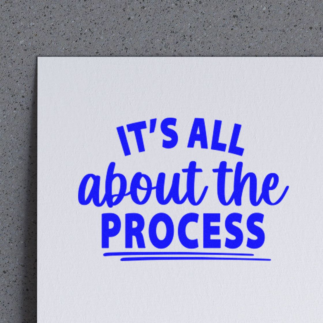 Blue ink stamp-style seal reading Its all about the process on white paper.