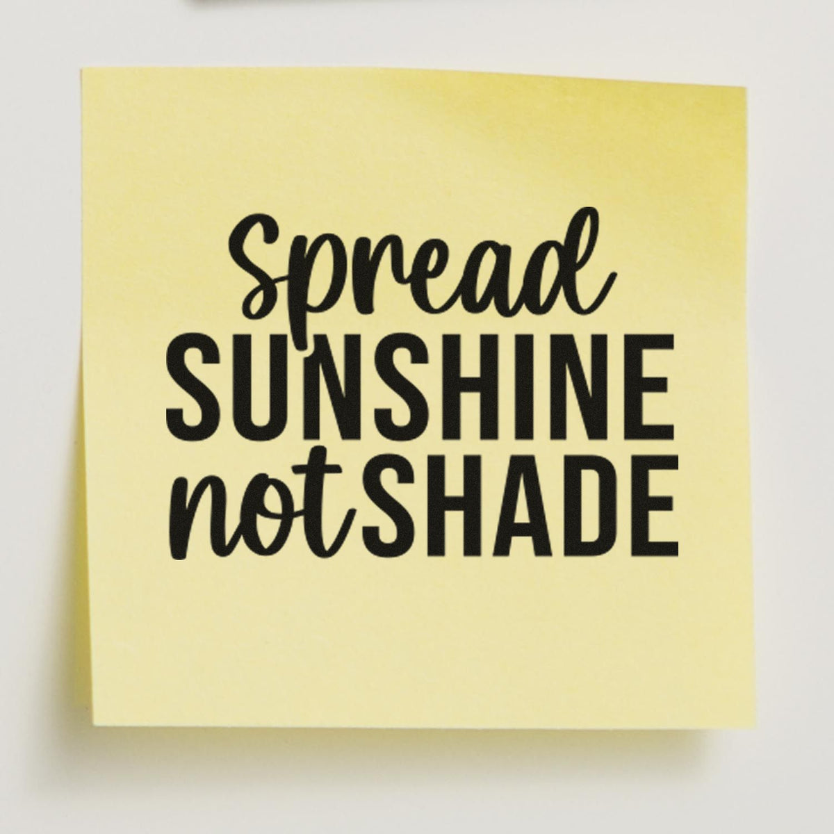 Yellow stamp and seal pad with black Spread Sunshine Not Shade lettering.