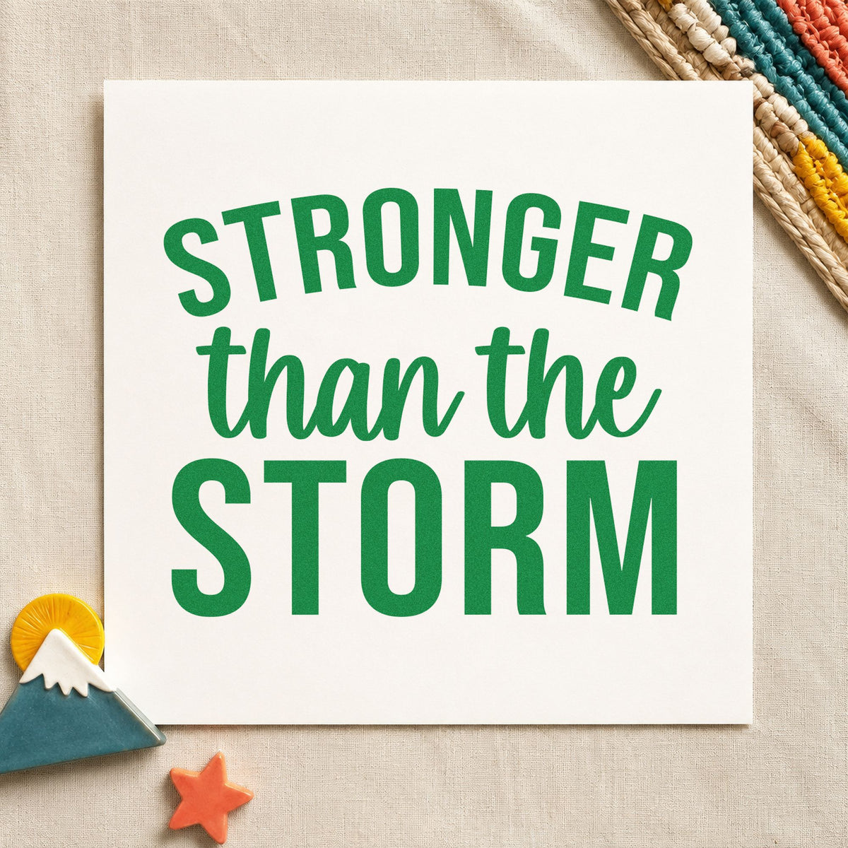 Stronger Than The Storm craft stamp imprint in green ink on a handmade project, one idea being street status cards.