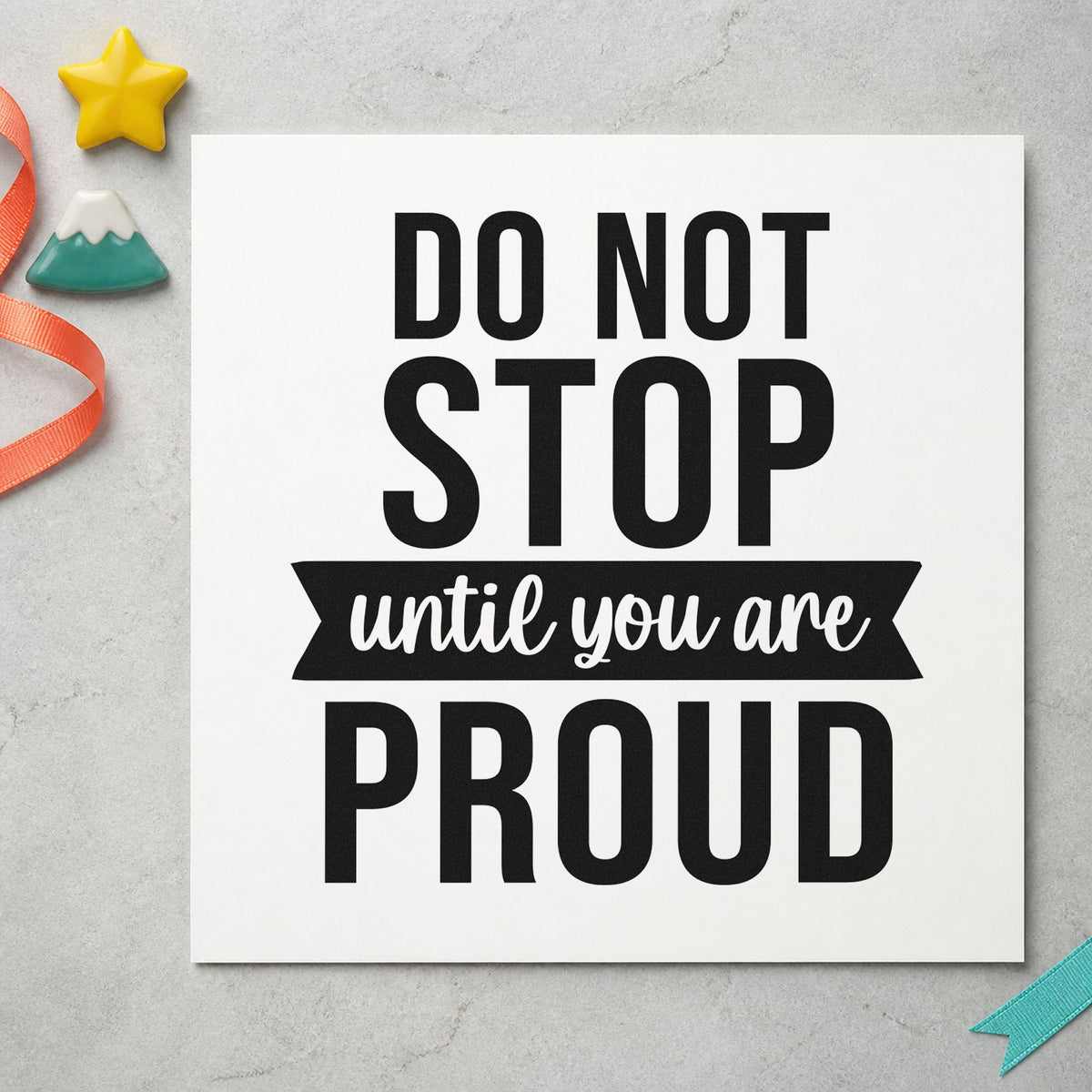 Don't Stop Until Proud craft stamp imprint in black ink on a handmade project, one idea being entry box gift tags.