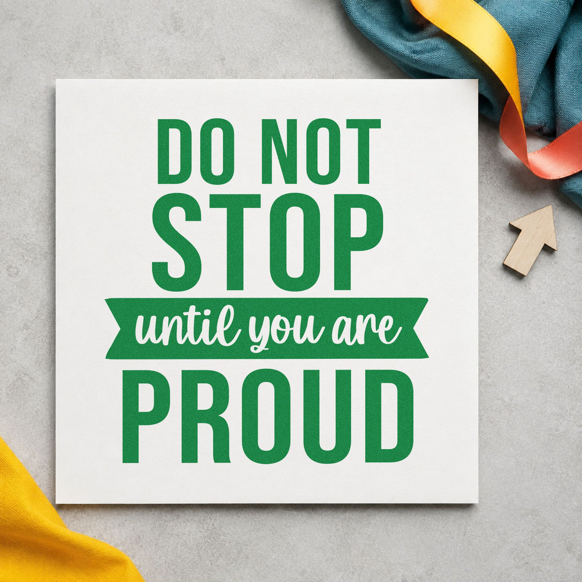 Don't Stop Until Proud craft stamp imprint in green ink on a handmade project, one idea being judge score cards.