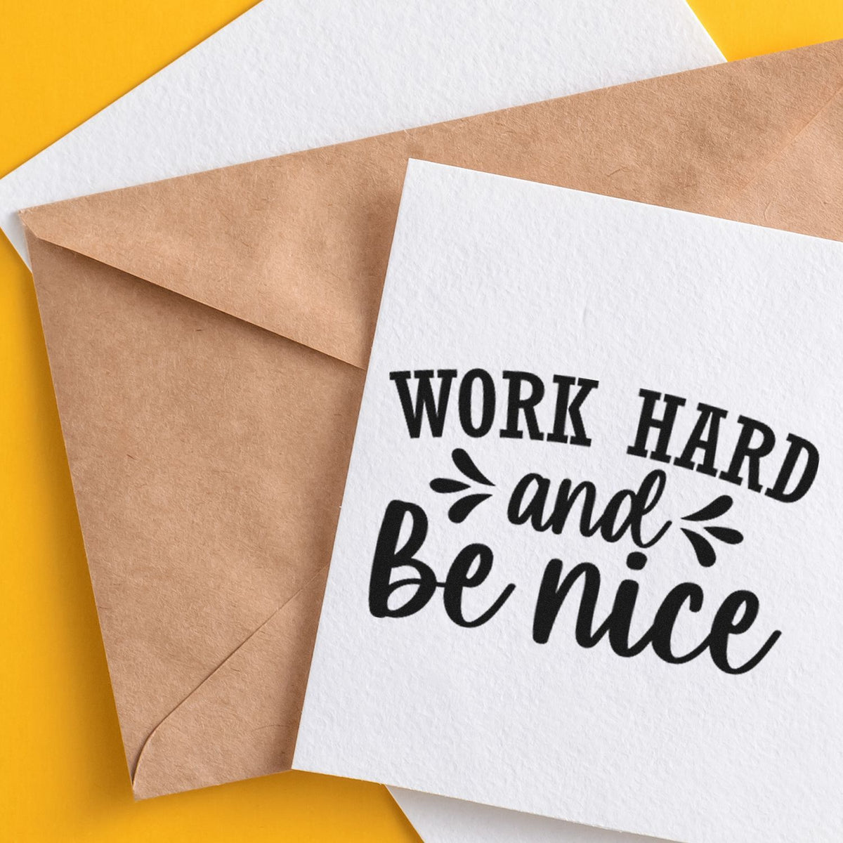 Custom stamp and seal card reading Work hard and be nice on kraft envelopes, black on white with yellow background.