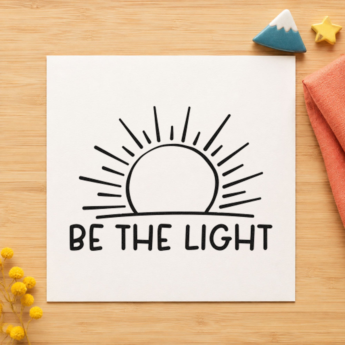 Be The Light Sunrise craft stamp imprint in black ink on a handmade project, one idea being race bib gift tags.