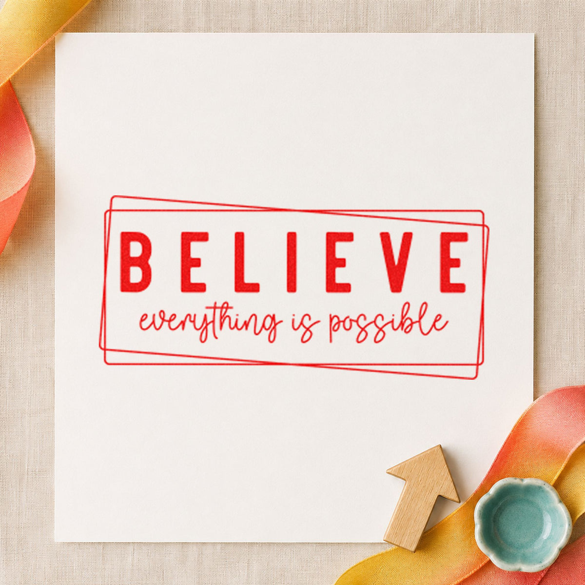 Believe Everything Is Possible craft stamp imprint in red ink on a handmade project, one idea being essay draft cards.