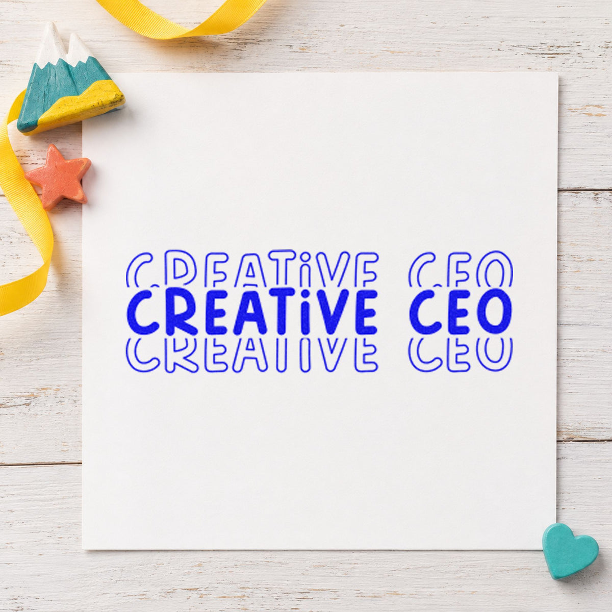 Creative CEO Repeated Lettering craft stamp in blue ink on cardstock, an easy option for press apron printing.