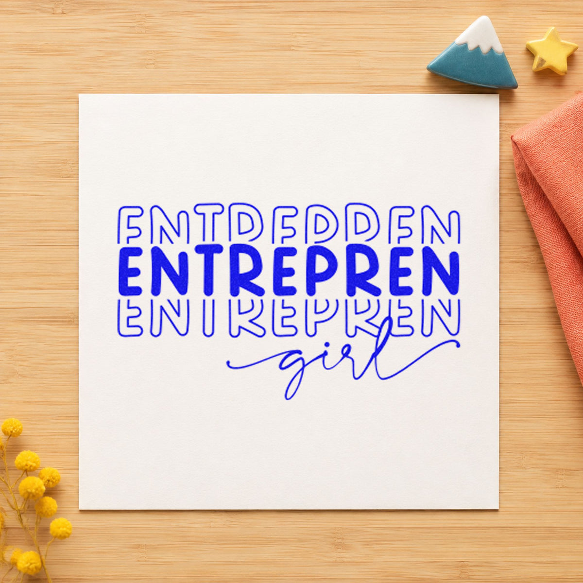 Entrepren Girl Repeated Lettering craft stamp in blue ink on cardstock, an easy option for wrap cloth printing.