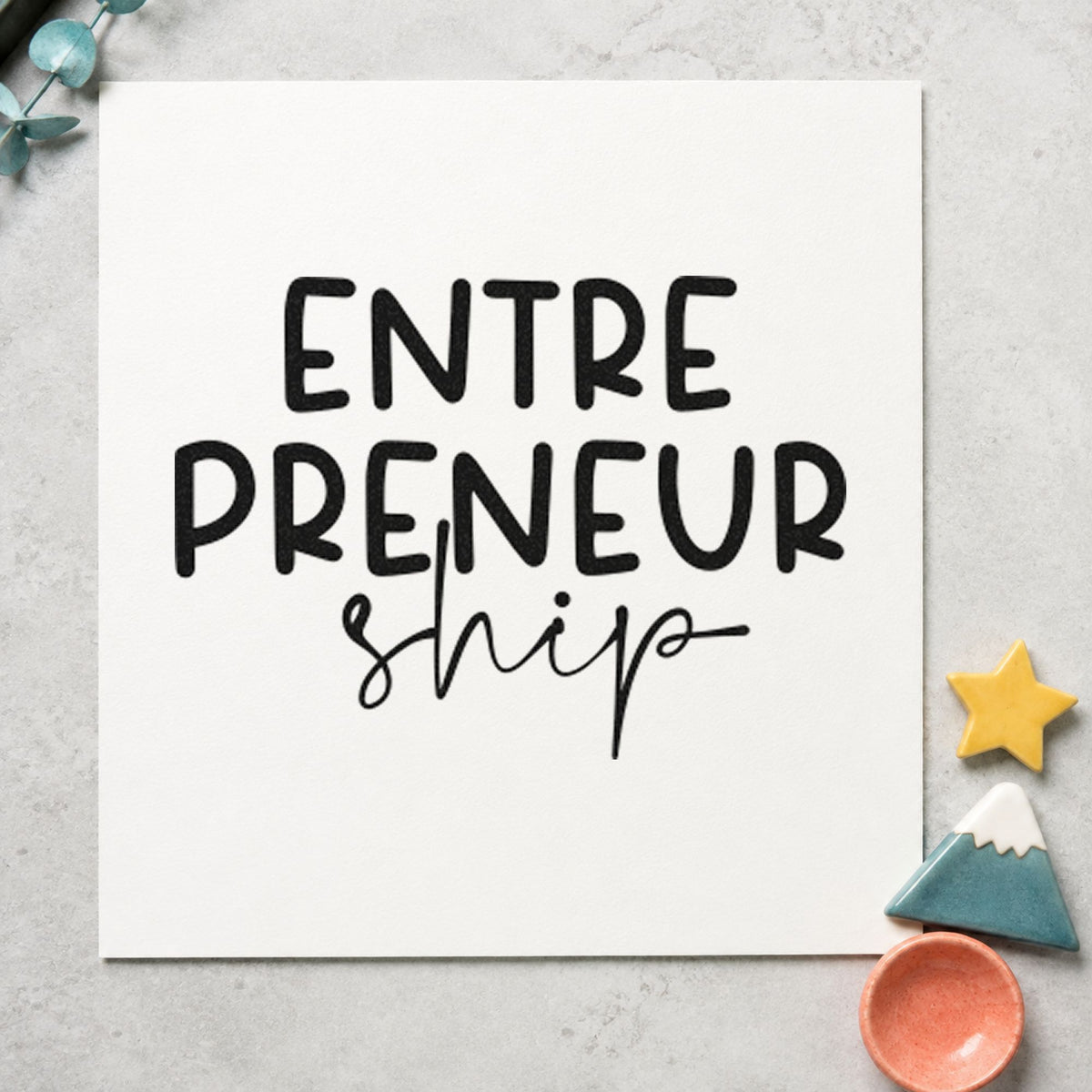 Entrepreneurship Split Lettering craft stamp imprint in black ink on a handmade project, one idea being carton gift tags.
