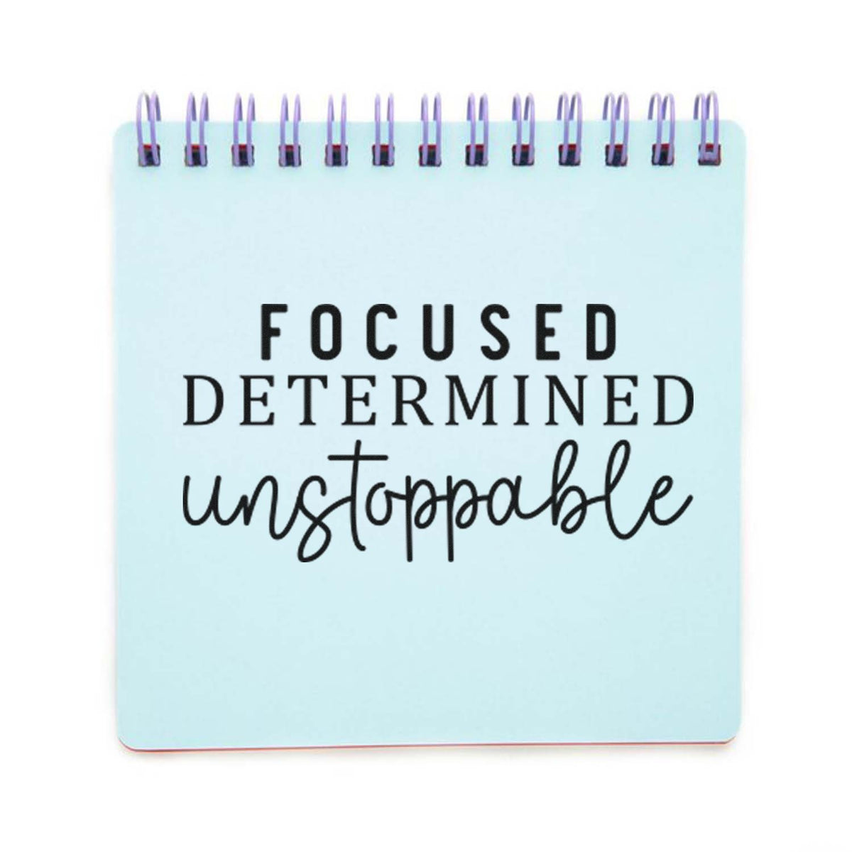 Light blue spiral notepad-style stamp with black motivational text: Focused, determined, unstoppable.