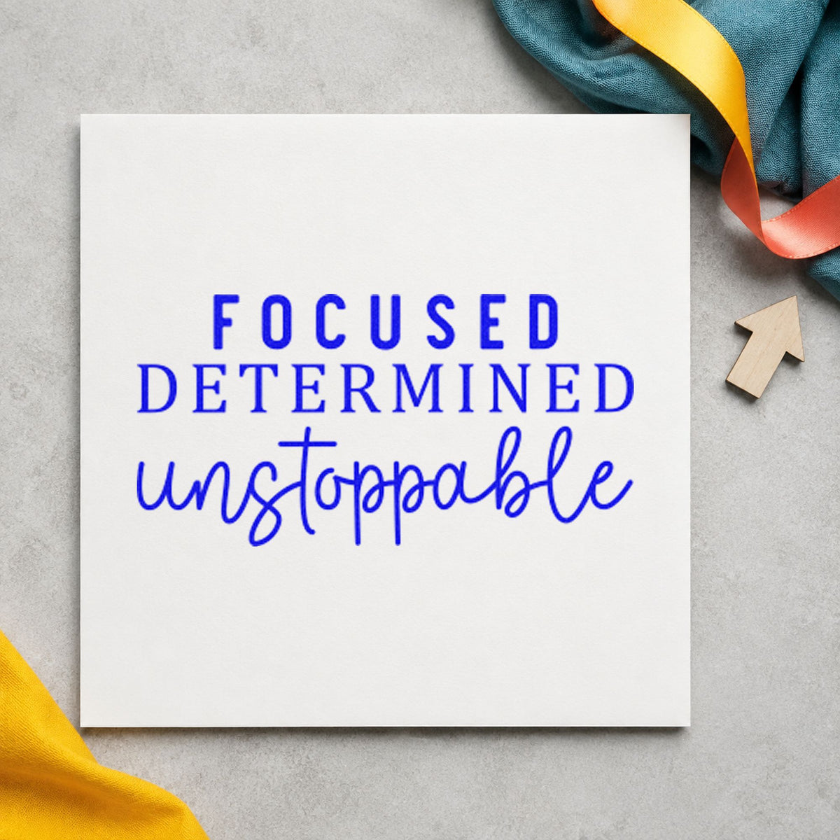 Focused Determined Unstoppable craft stamp in blue ink on cardstock, an easy option for desk mat printing.
