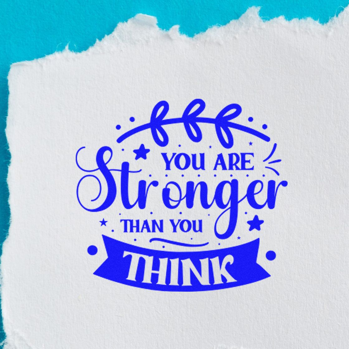 Blue motivational stamp and seal on white paper with torn edge, reading You Are Stronger Than You Think.