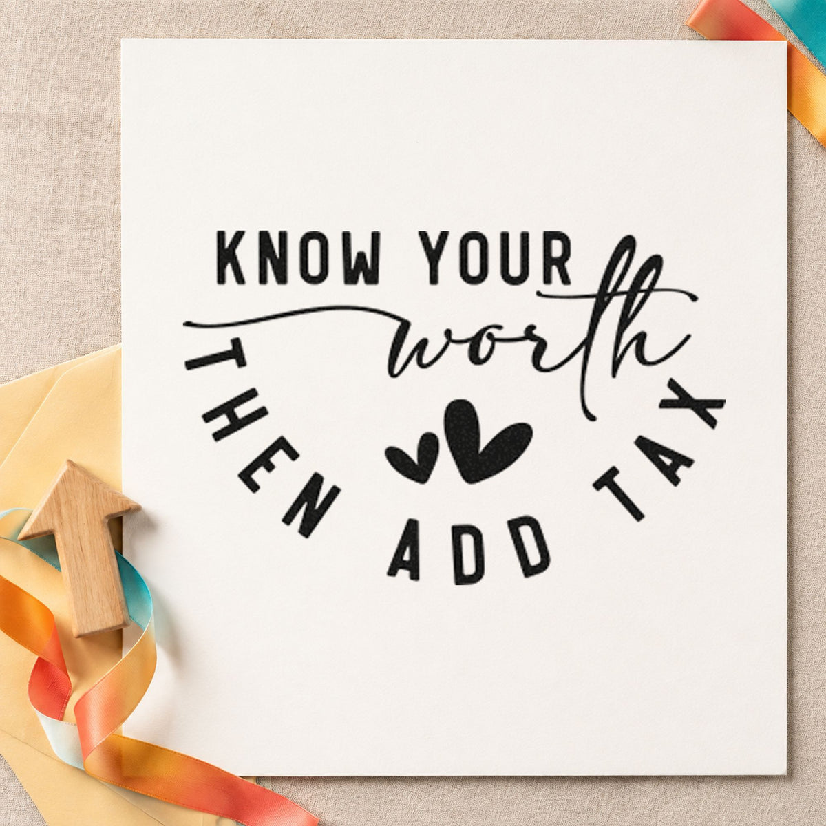 Know Your Worth Add Tax craft stamp imprint in black ink on a handmade project, one idea being sold item gift tags.