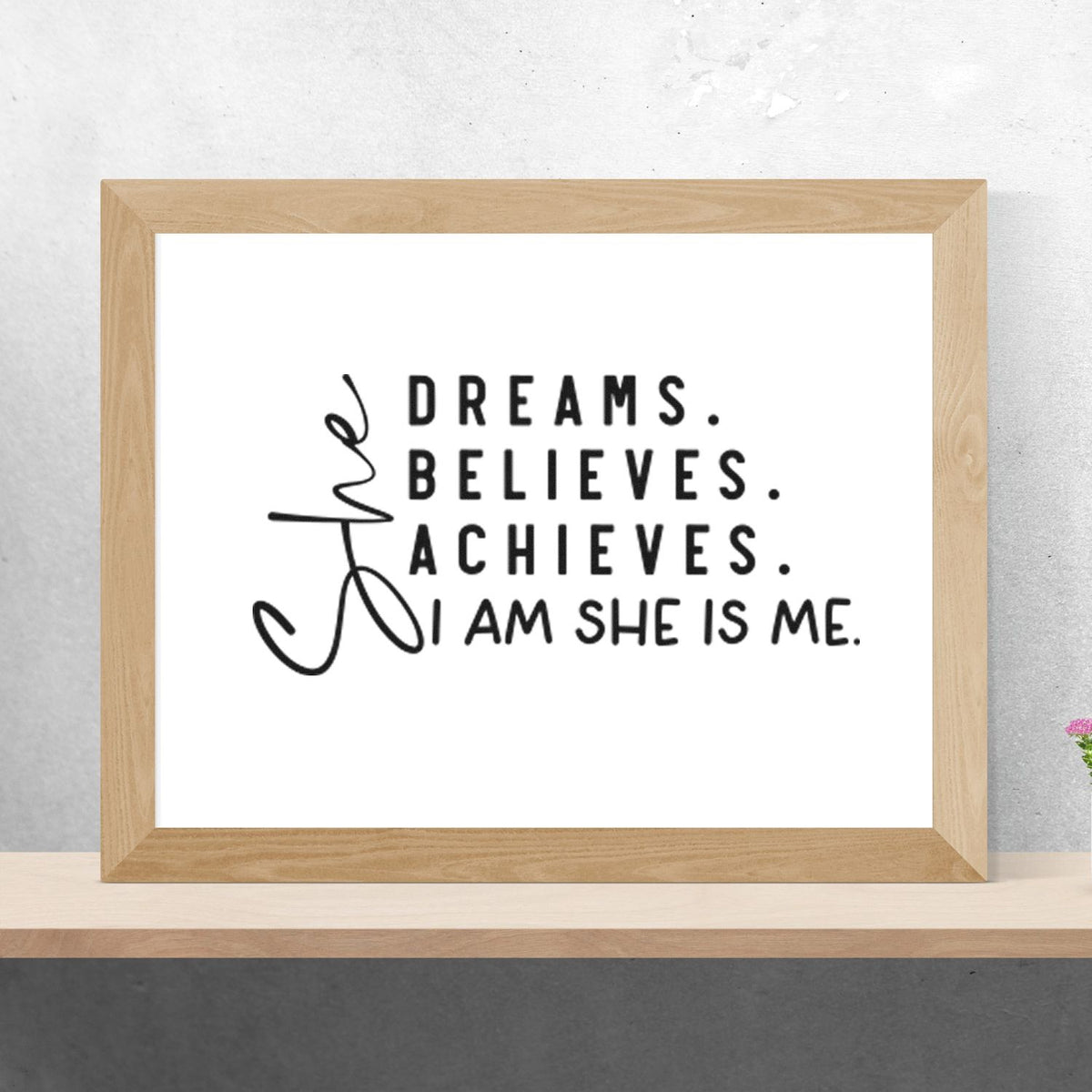 Natural wood-framed custom stamp seal with black text on white: Dreams. Believes. Achieves. I am she is me.