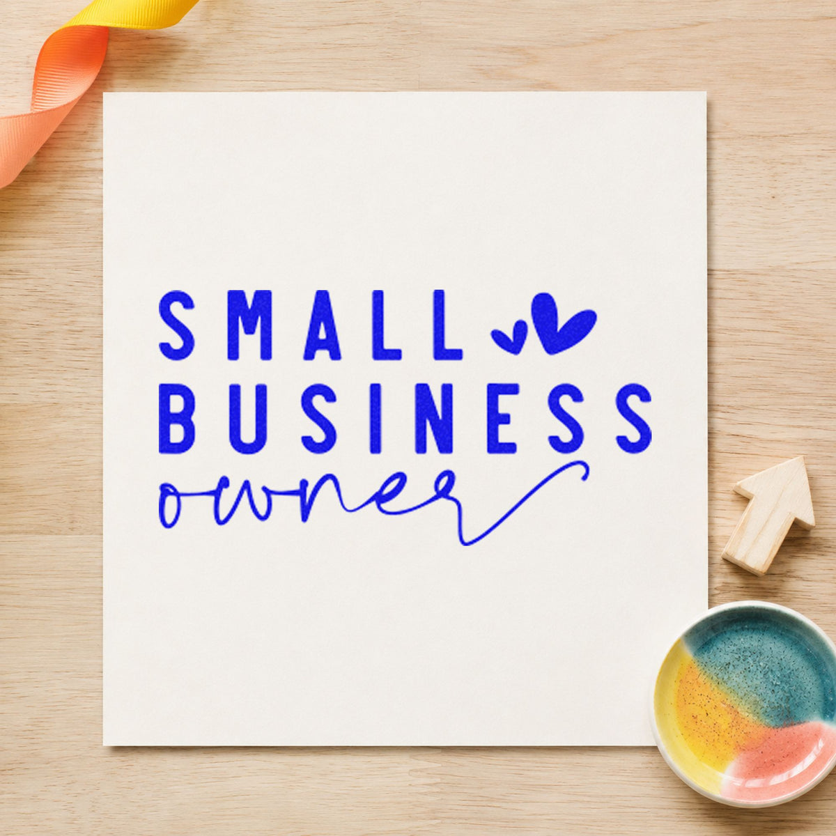 Small Business Owner Hearts craft stamp in blue ink on cardstock, an easy option for shop rag printing.