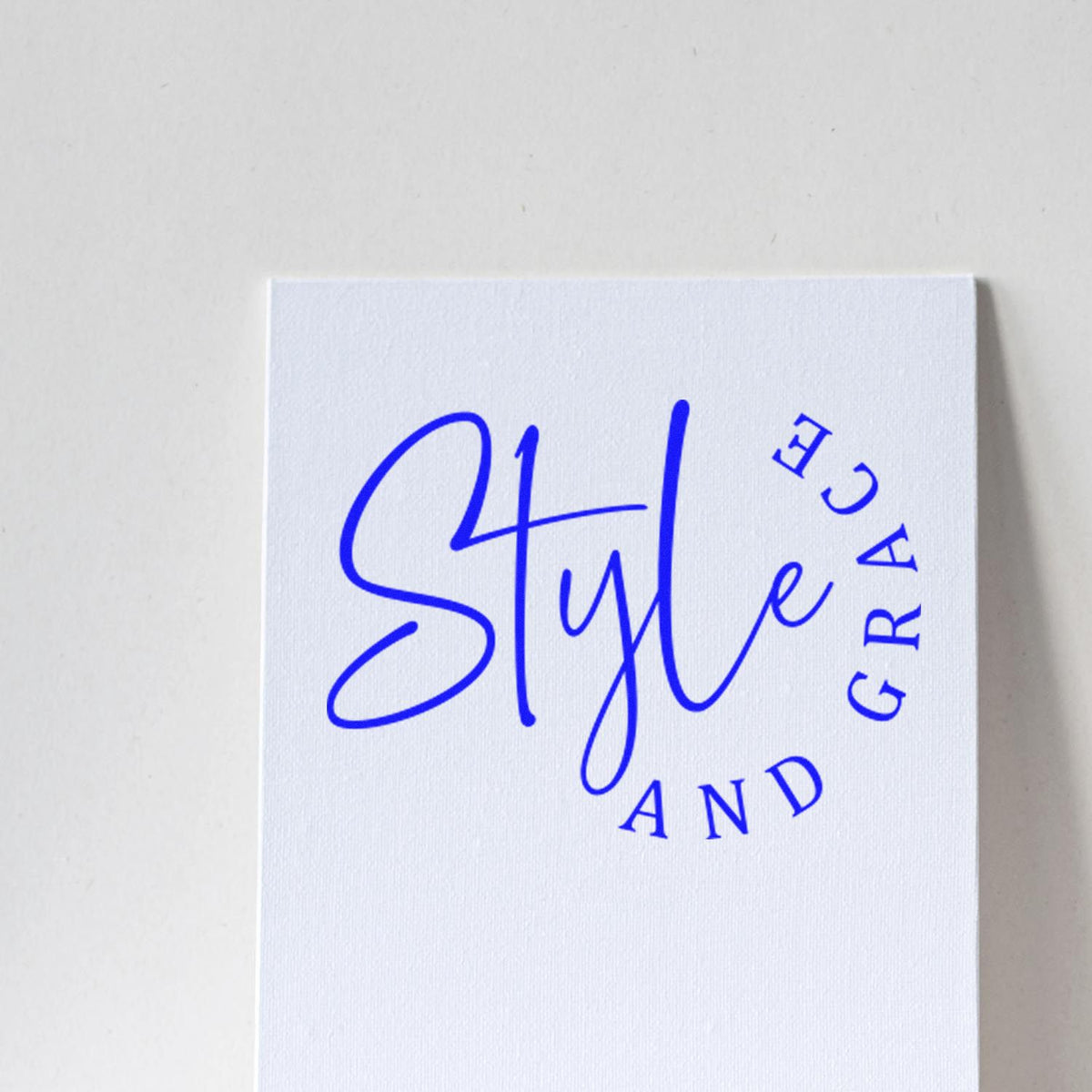 White stamp seal card with bold blue Style and Grace lettering and curved logo text