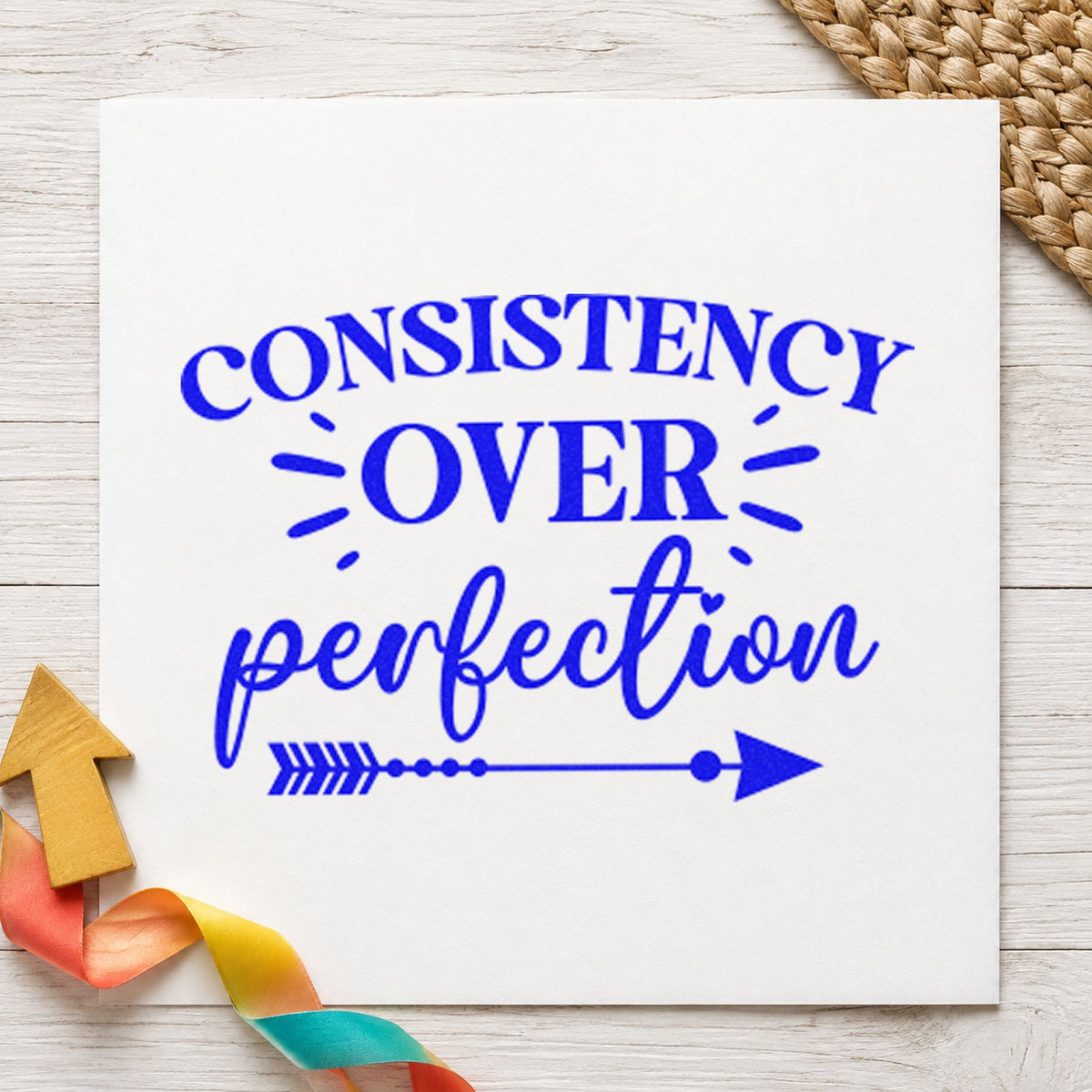 Consistency Over Perfection Arrow craft stamp in blue ink on cardstock, an easy option for book sleeve printing.