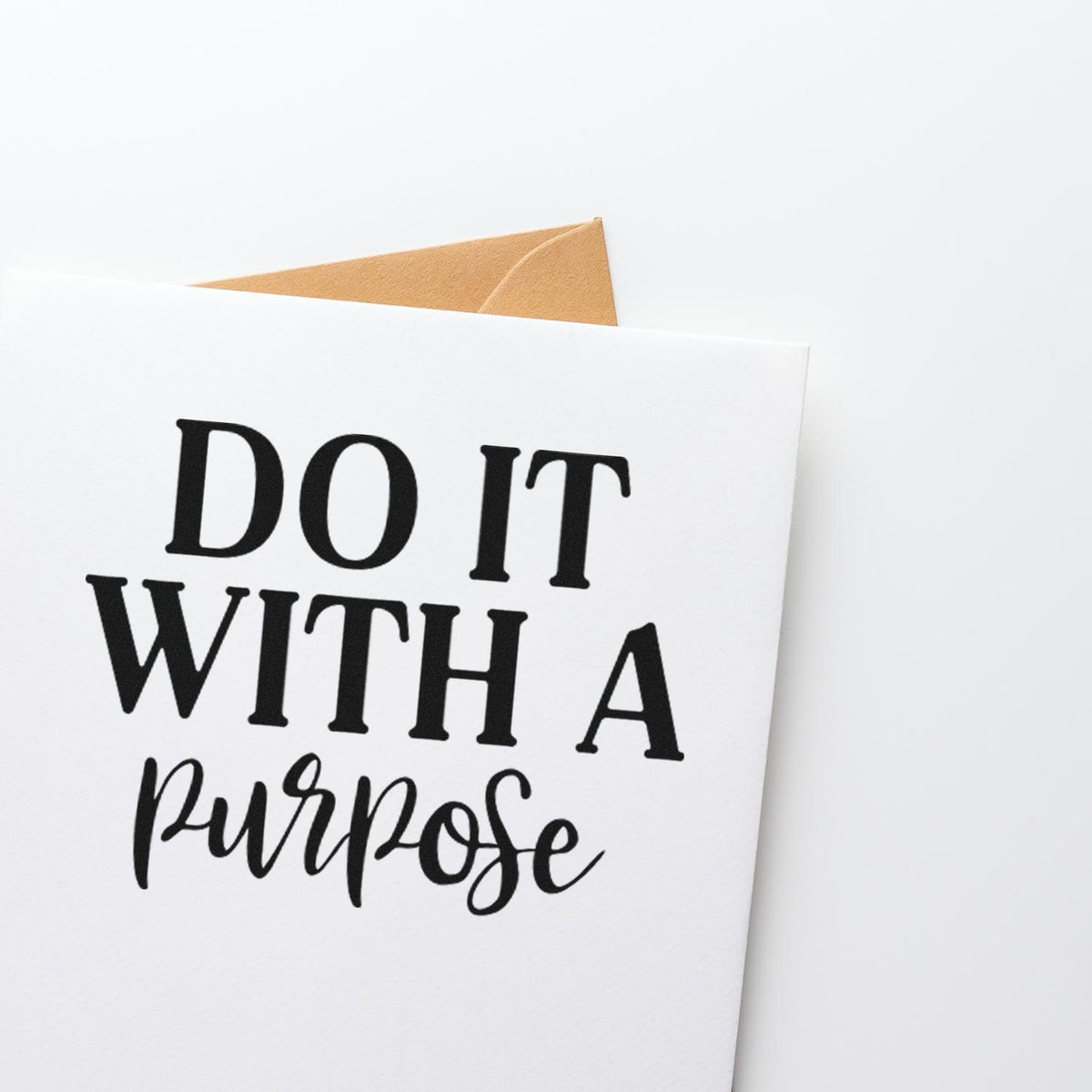 Custom stamp and seal card with black DO IT WITH A purpose lettering on white paper and a tan envelope.