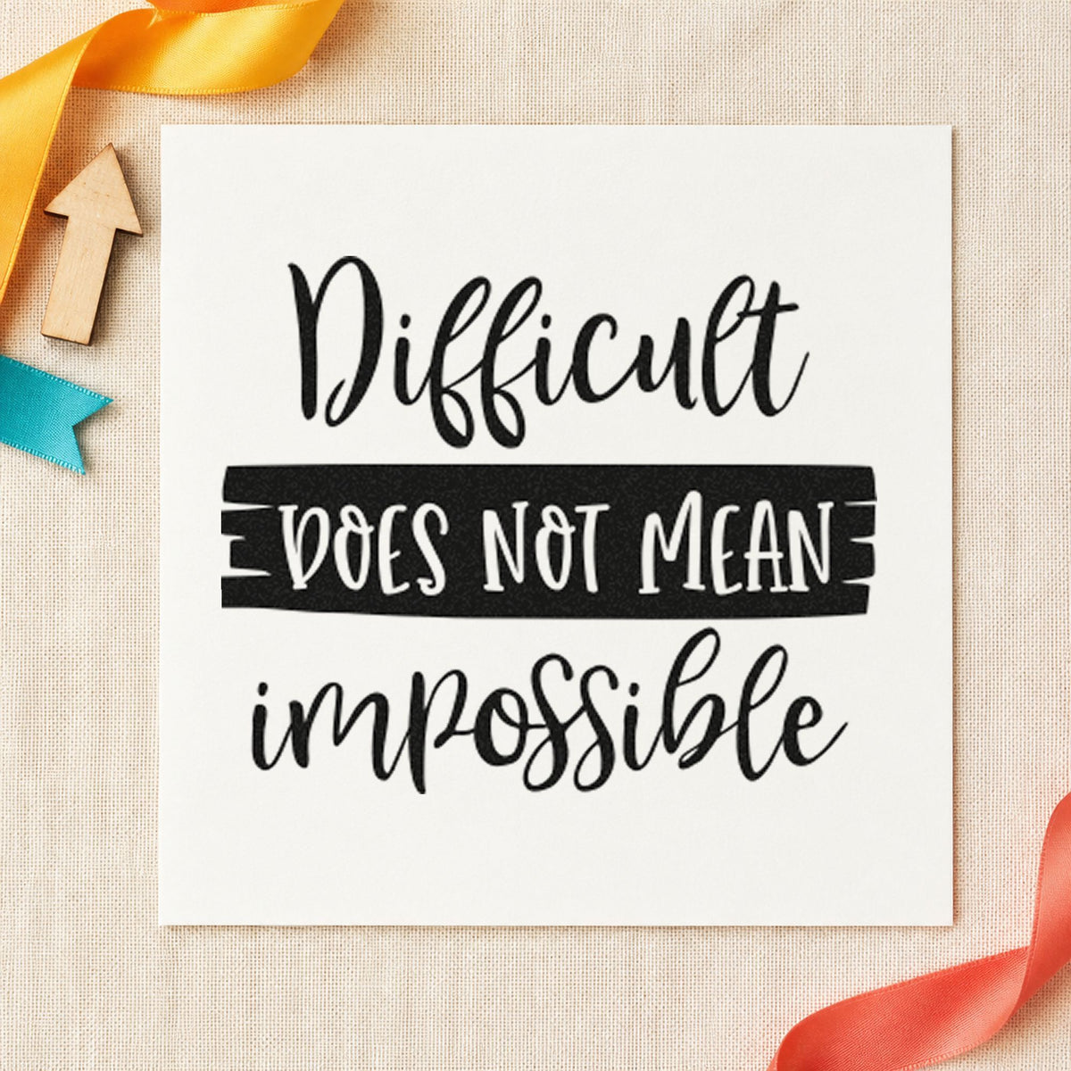Difficult Does Not Mean Impossible craft stamp imprint in black ink on a handmade project, one idea being puzzle loan gift tags.