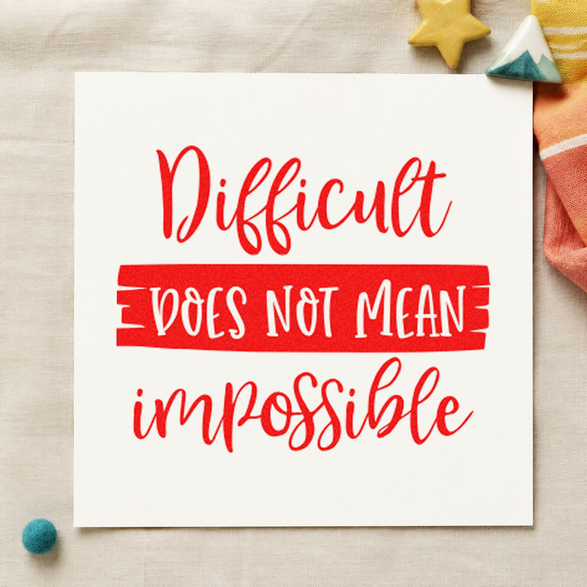 Difficult Does Not Mean Impossible craft stamp imprint in red ink on a handmade project, one idea being clue round cards.