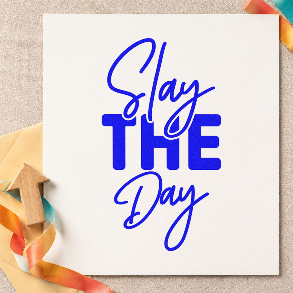 Slay The Day craft stamp in blue ink on cardstock, an easy option for class banner printing.