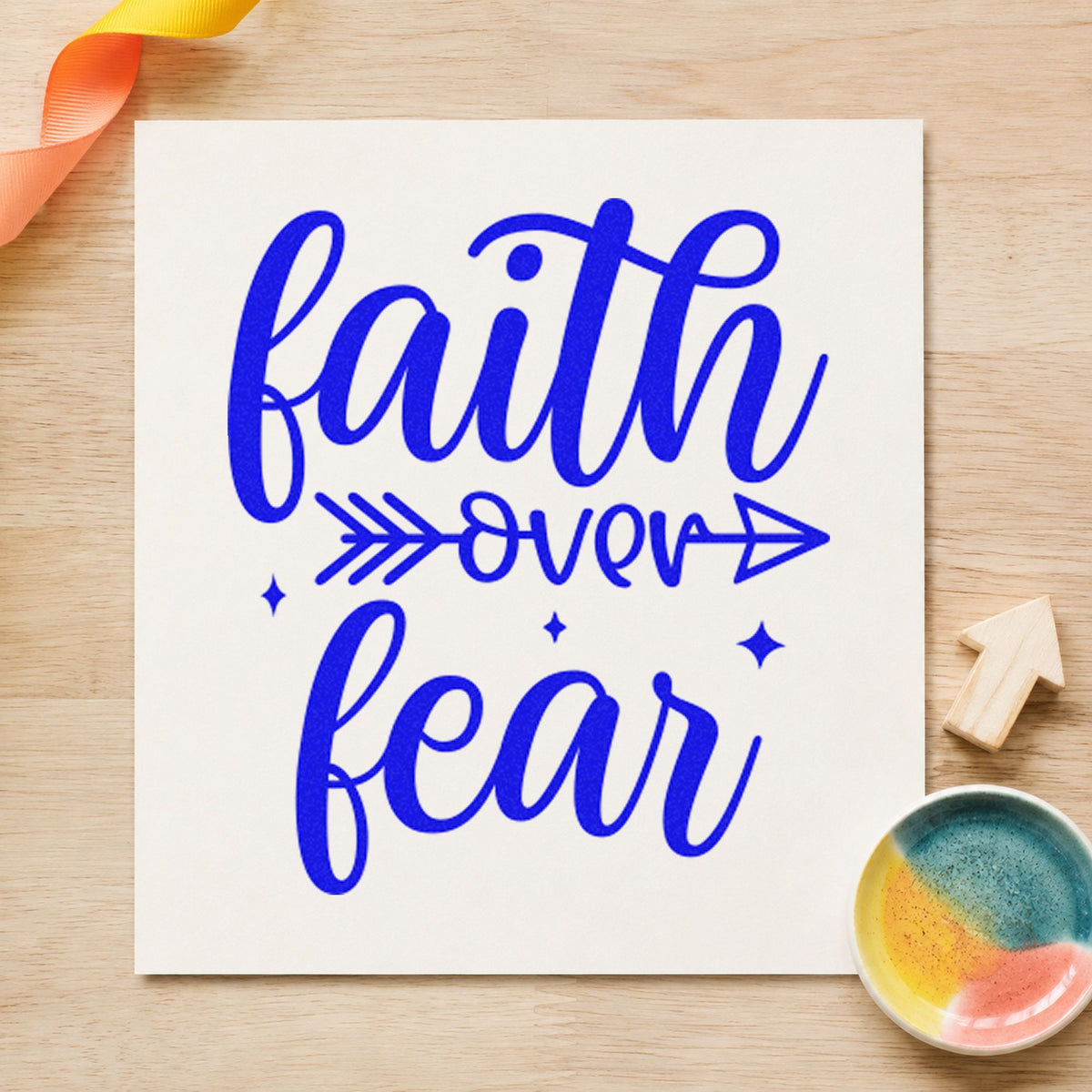 Faith Over Fear Arrow craft stamp in blue ink on cardstock, an easy option for team tee printing.