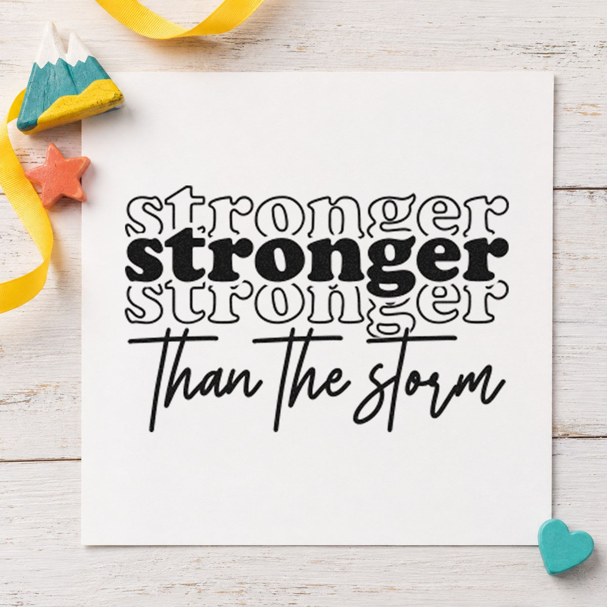 Stronger Than The Storm Repeated craft stamp imprint in black ink on a handmade project, one idea being gear bag gift tags.