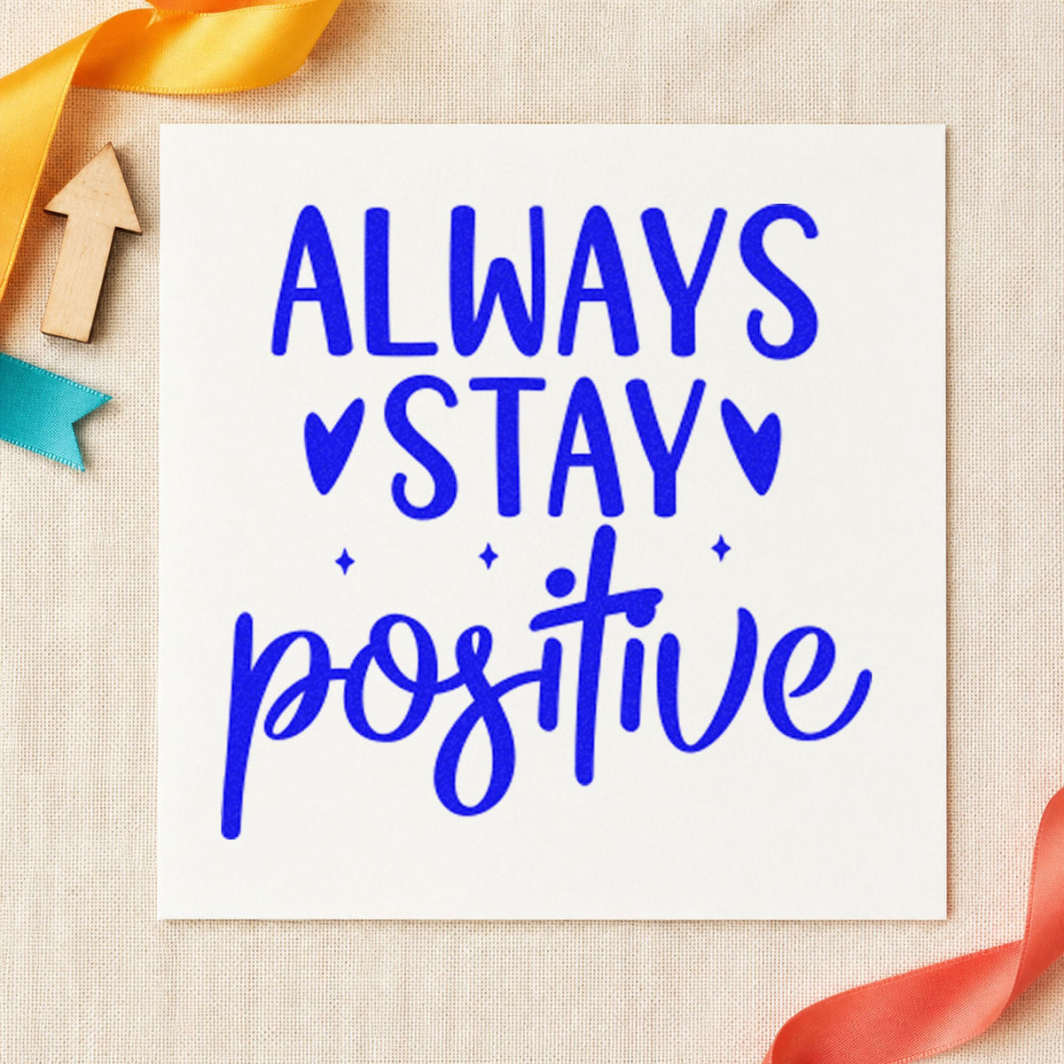 Always Stay Positive Hearts craft stamp in blue ink on cardstock, an easy option for hooded towel printing.