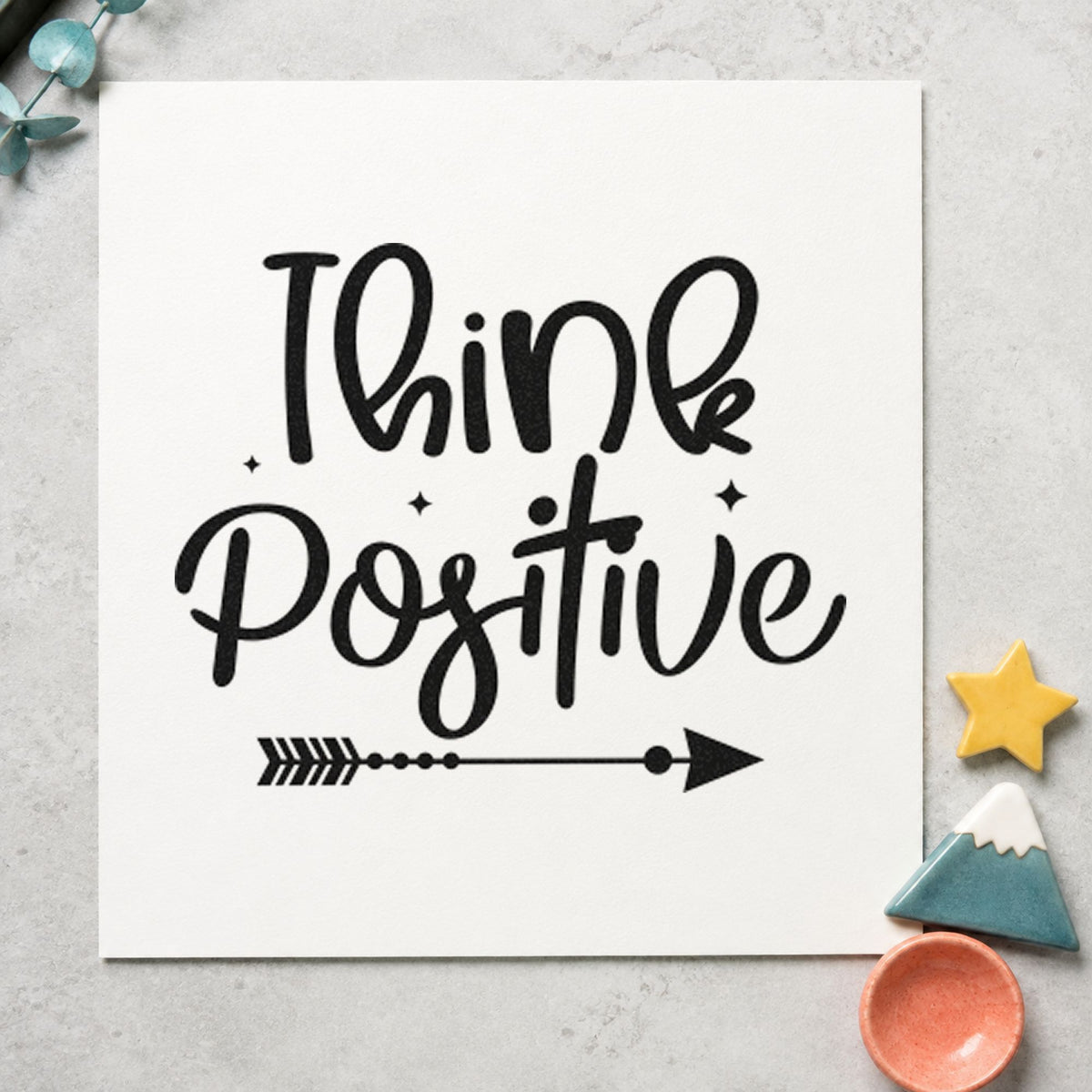Think Positive Arrow craft stamp imprint in black ink on a handmade project, one idea being holiday gift tags.
