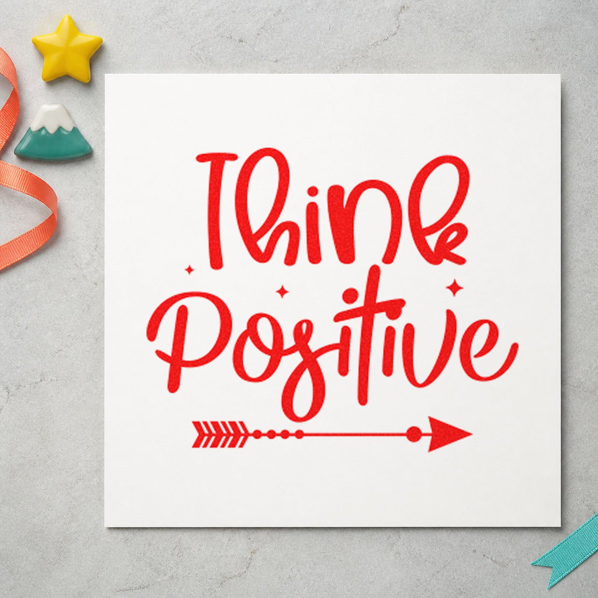 Think Positive Arrow craft stamp imprint in red ink on a handmade project, one idea being rider thanks cards.