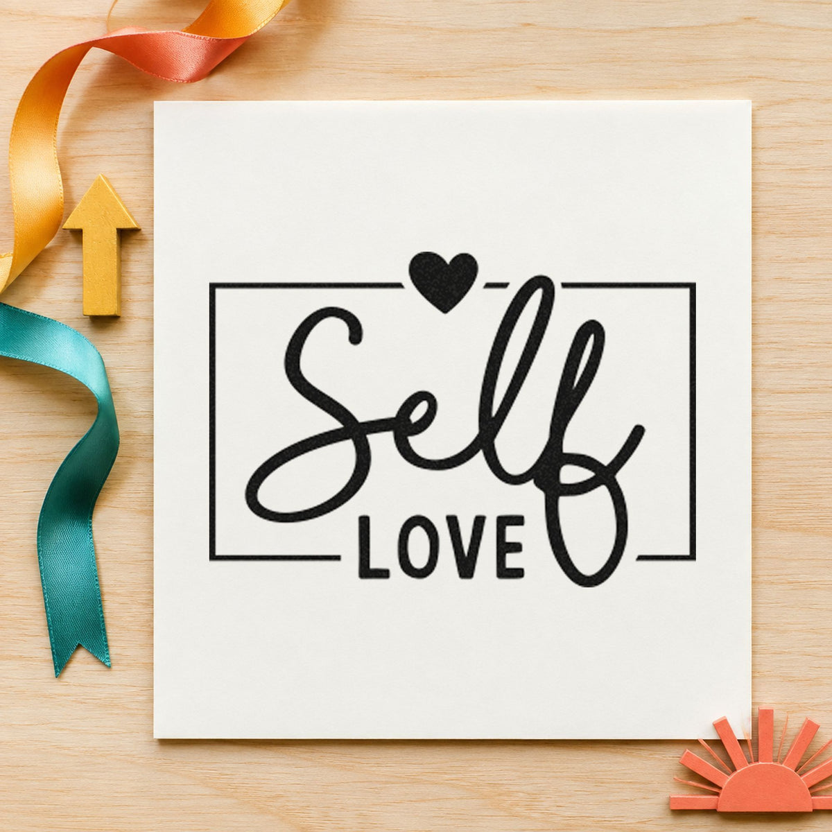 Self Love Framed Heart craft stamp imprint in black ink on a handmade project, one idea being oil blend gift tags.