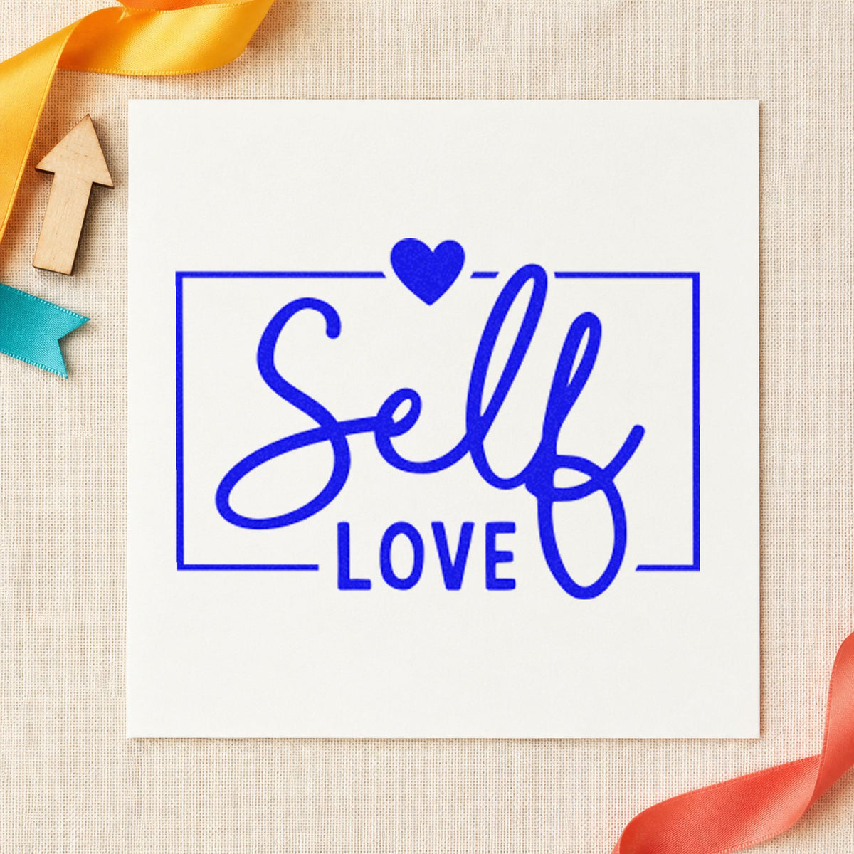 Self Love Framed Heart craft stamp in blue ink on cardstock, an easy option for table drape printing.