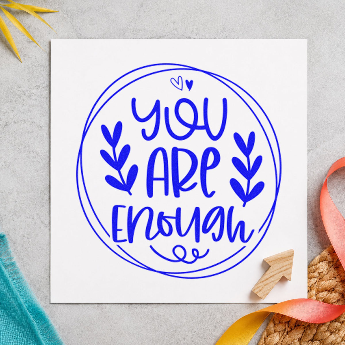 You Are Enough Circle Leaves craft stamp in blue ink on cardstock, an easy option for laundry bag printing.