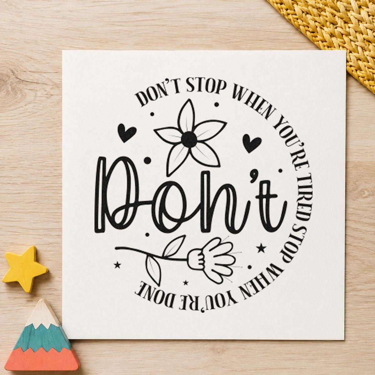 Don't Stop When Tired Floral craft stamp imprint in black ink on a handmade project, one idea being reference gift tags.