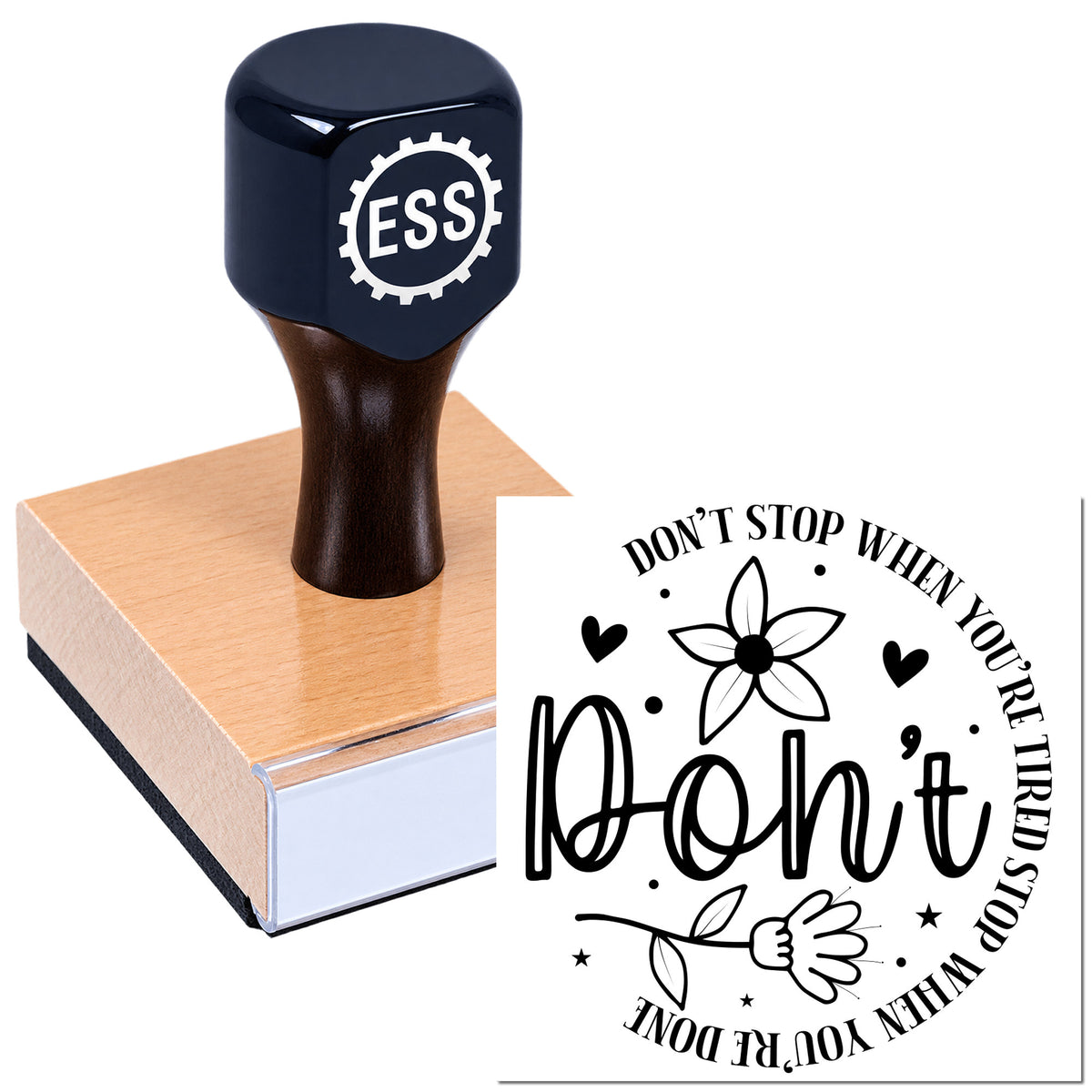 Black ESS rubber stamp on a pink wooden base, showing a floral seal that says "Don't stop when you're tired, stop when you're done."