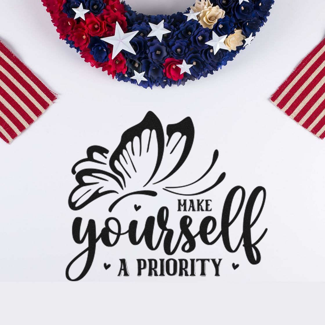 Black butterfly stamp seal reading Make yourself a priority on white, framed by red, navy, and cream patriotic decor.