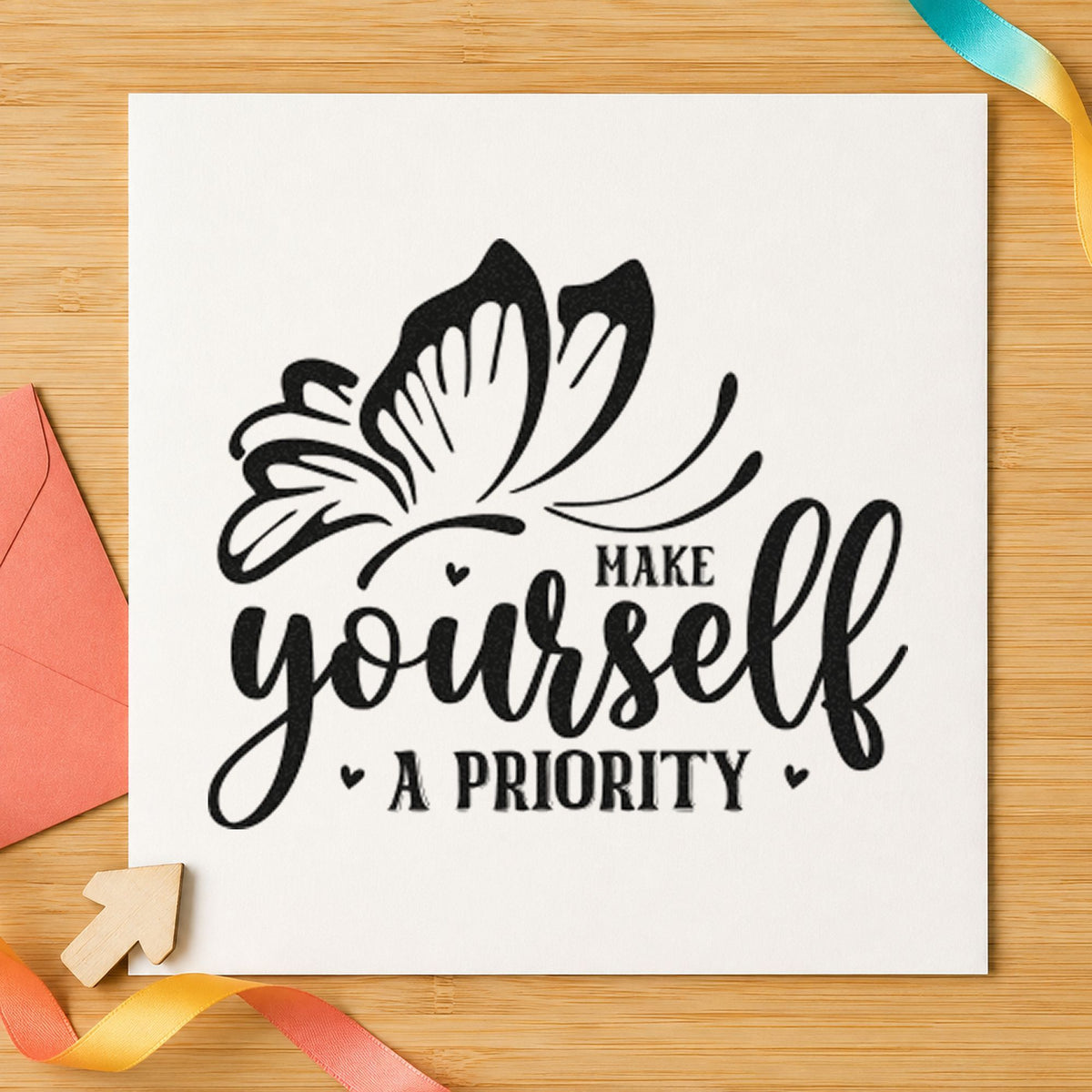 Make Yourself A Priority Butterfly craft stamp imprint in black ink on a handmade project, one idea being water bottle tags.