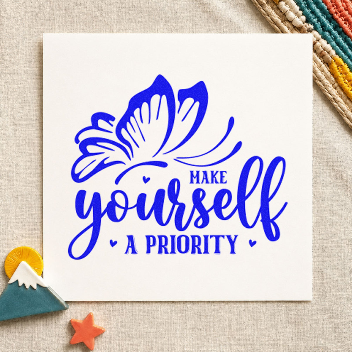 Make Yourself A Priority Butterfly craft stamp imprinted in blue ink on paper, a design suited to framed office landing.