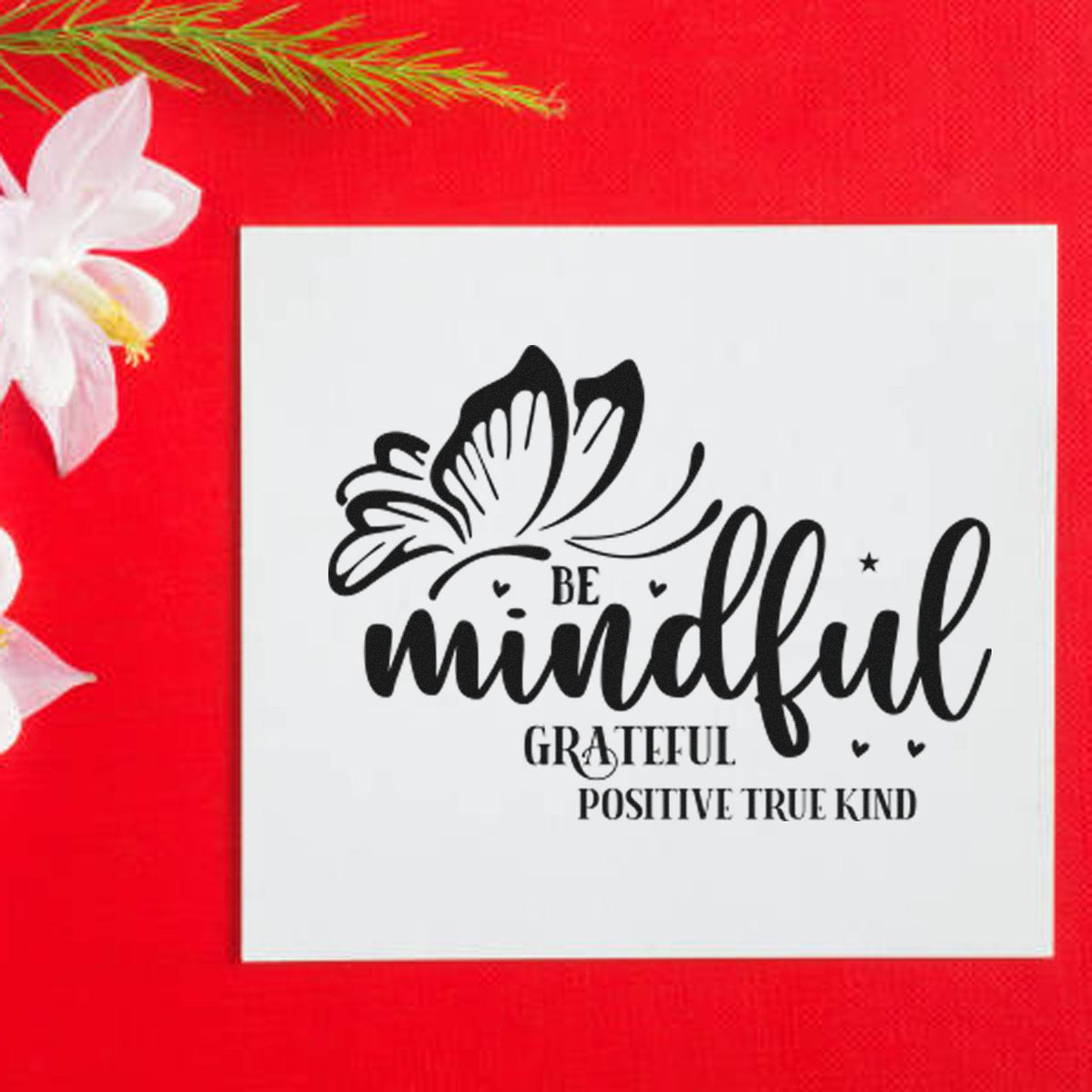 Black mindfulness stamp seal with butterfly and gratitude text on white card, on bright red background with white flower.