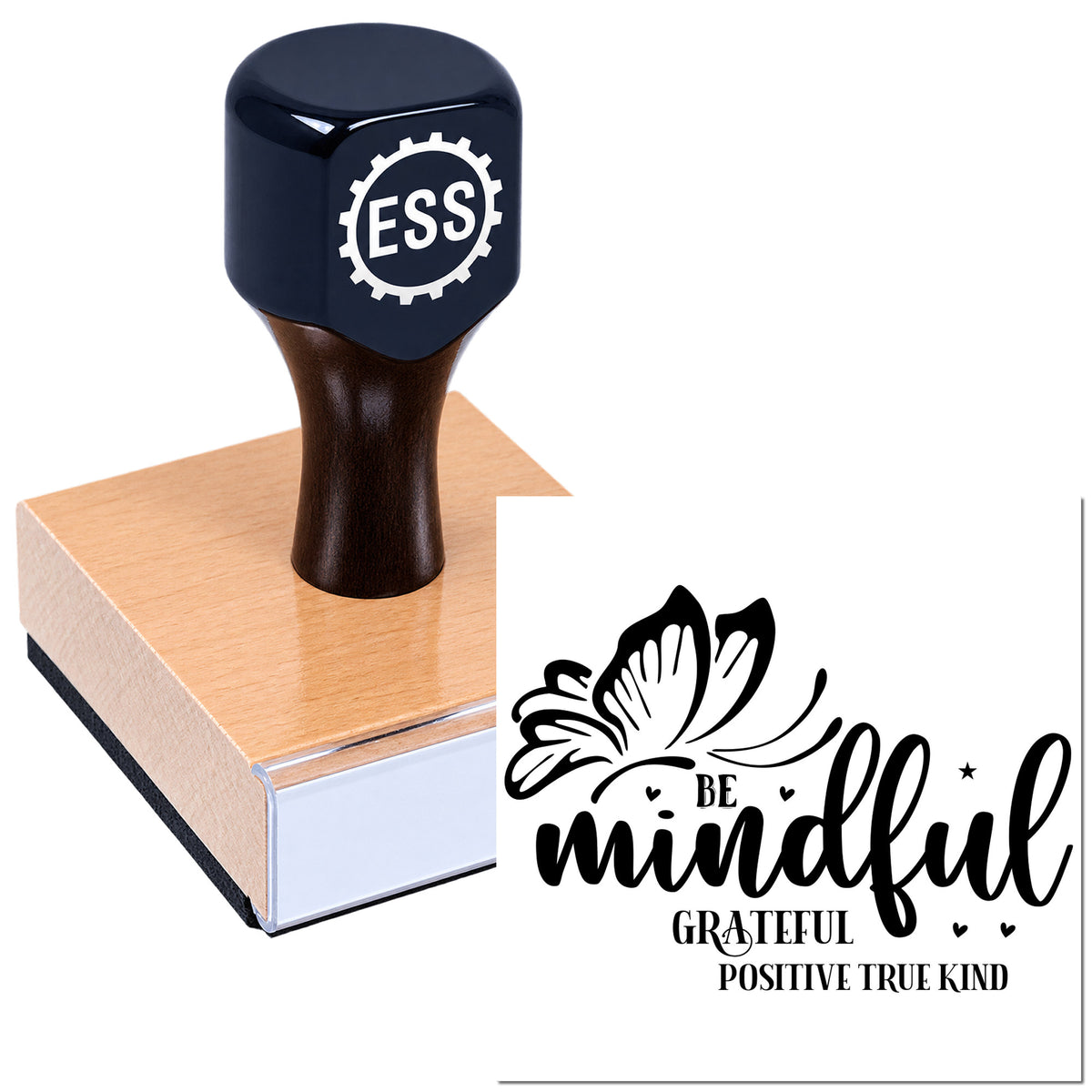 Black ESS stamp on pink wooden block with butterfly seal reading "be mindful, grateful, positive, true, kind" on white