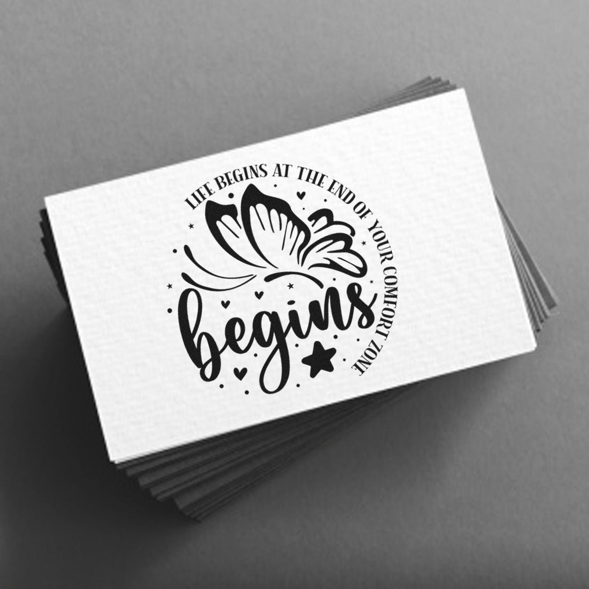 Black custom stamp and seal with butterfly and begins quote on a white card, stacked on a gray background.