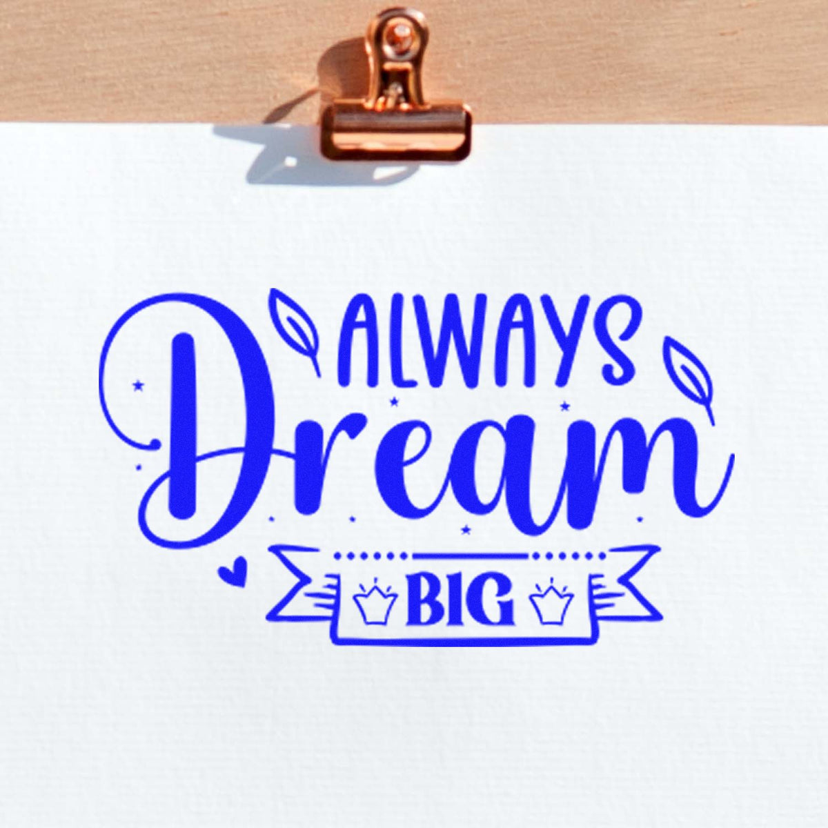 Blue Always Dream Big stamp seal on white paper, clipped with a copper binder clip