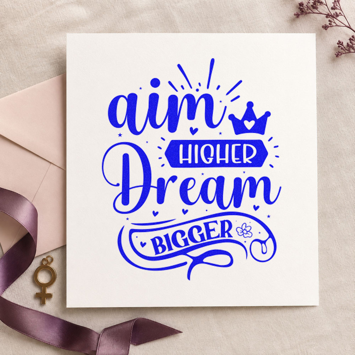 Aim Higher Dream Bigger Crown craft stamp in blue ink on cardstock, an easy option for warmup shirt printing.