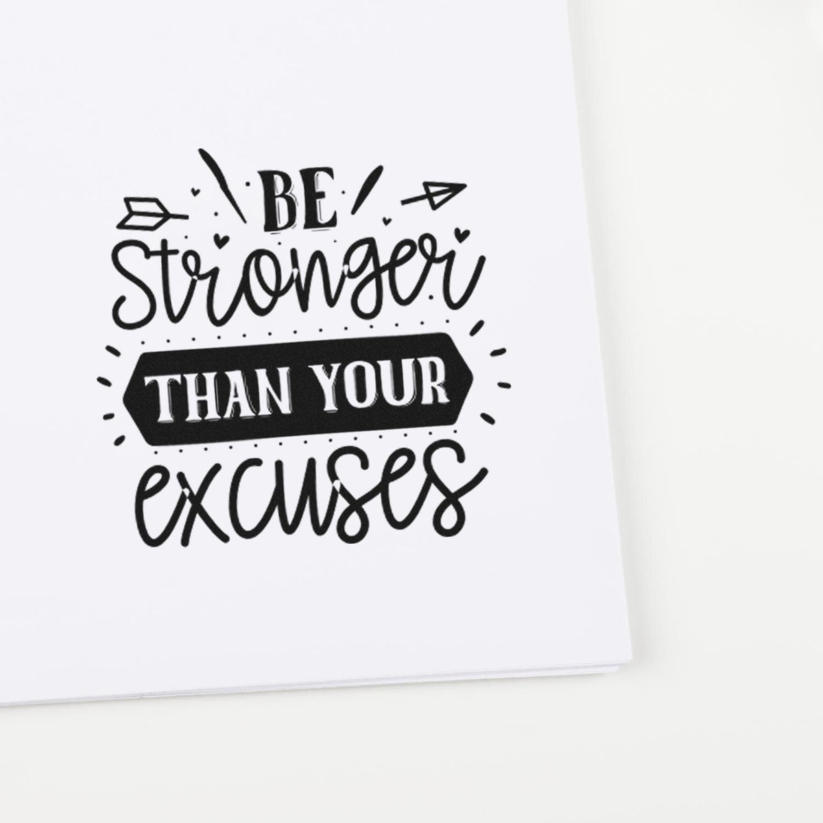 Black motivational stamp seal reading Be Stronger Than Your Excuses in mixed script and bold type on white paper.
