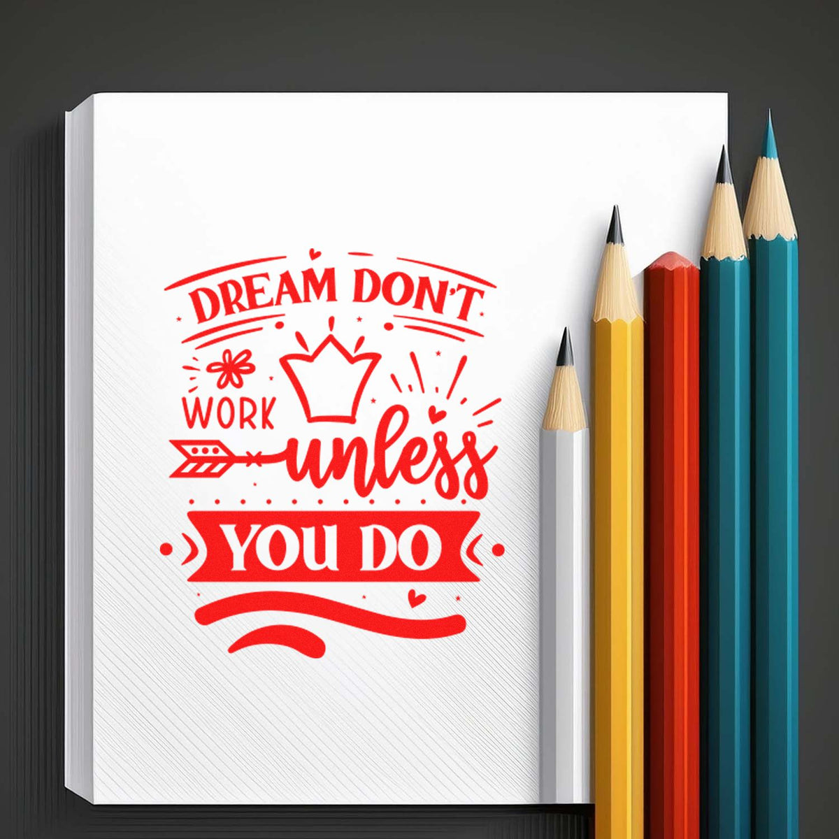 Red stamp seal design reading Dream dont work unless you do on white paper, beside yellow, teal, white and red pencils.