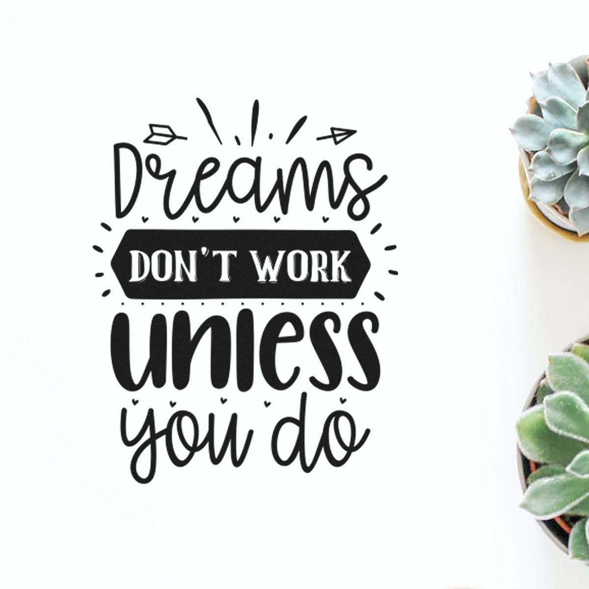 Black seal-style stamp design reading Dreams dont work unless you do with white text and succulents on the right.