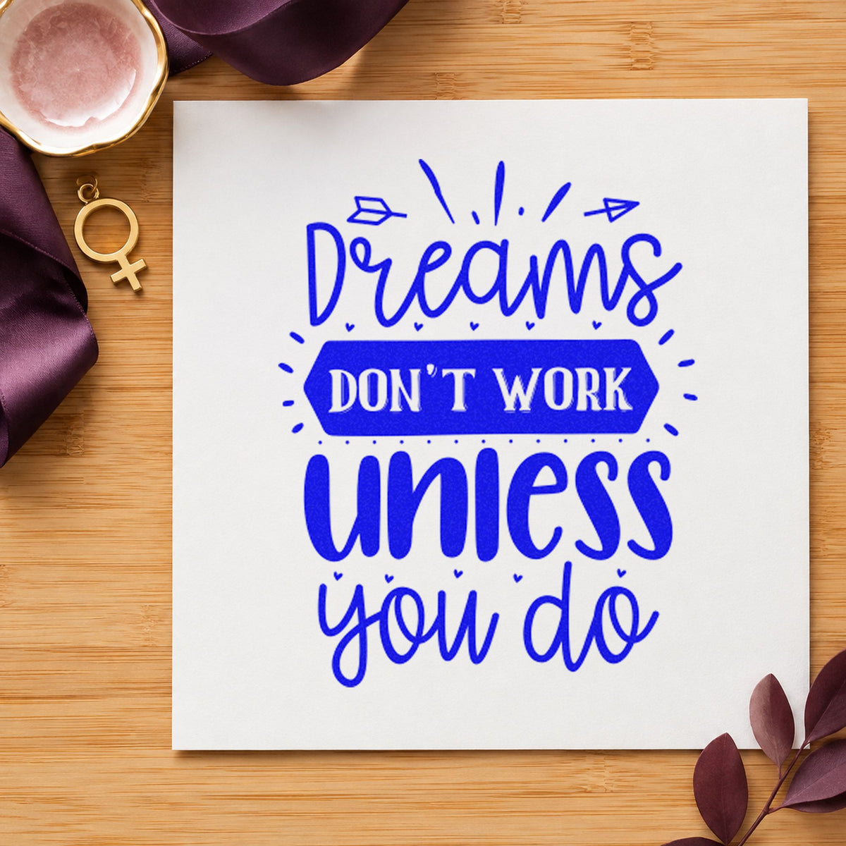 Dreams Don't Work Unless You Do craft stamp imprinted in blue ink on paper, a design suited to framed home desk.