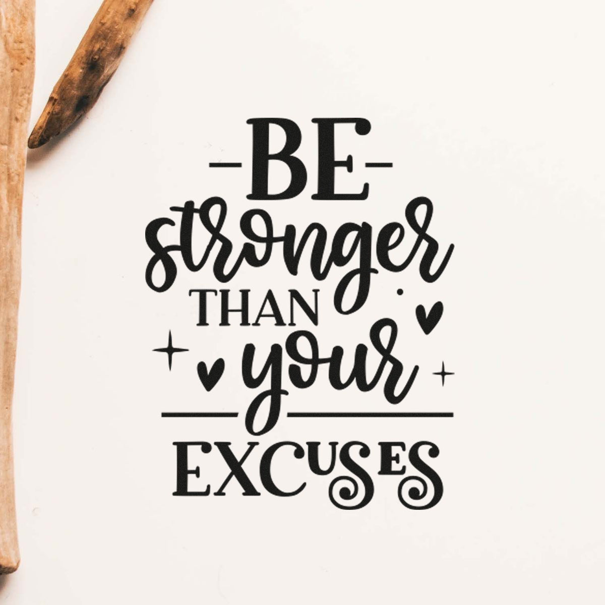 Black stamp and seal design reading Be stronger than your excuses on white, with wooden handles along the left edge.