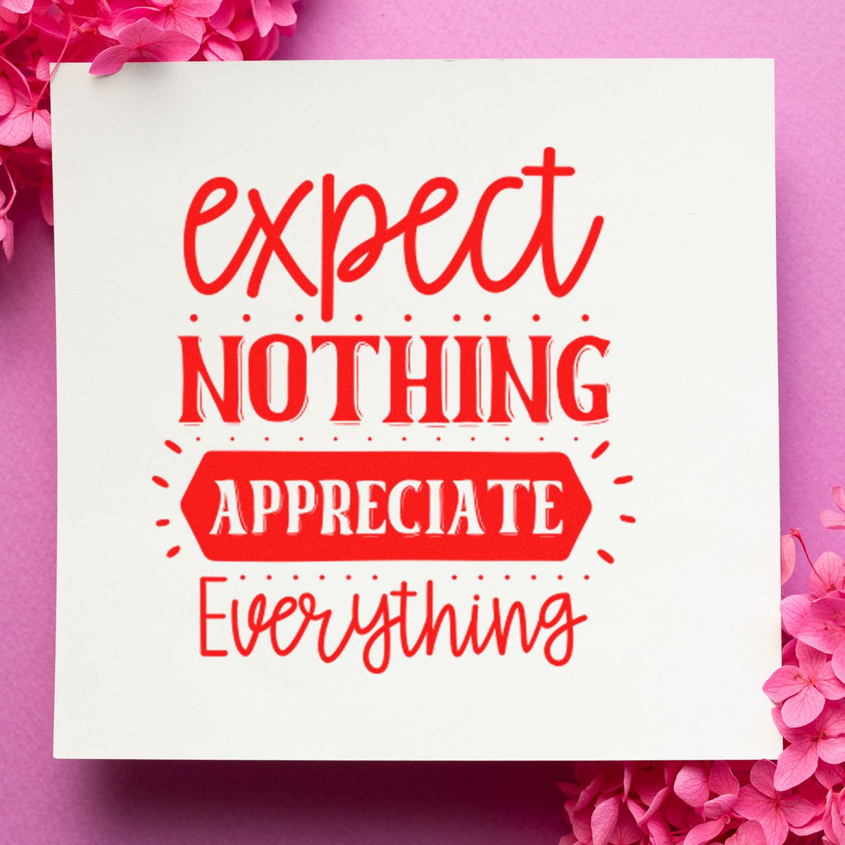 White stamp and seal design with red expect nothing, appreciate everything lettering on a pink floral background.