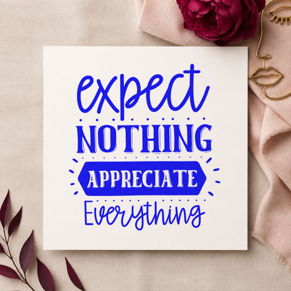 Expect Nothing Appreciate Everything craft stamp imprinted in blue ink on paper, a design suited to framed empty wall.