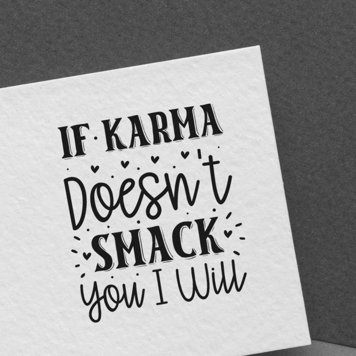 Black custom stamp on white card reading If karma doesnt smack you I will, with small hearts on gray background.